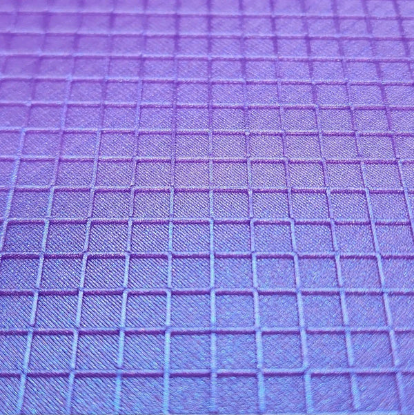 Purple grid-patterned crafting mat for rhinestone tumbler designs