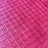 Pink textured crafting mat with grid pattern for rhinestone tumbler projects