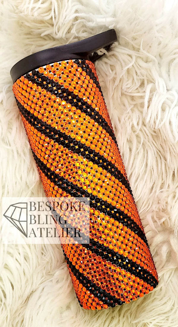 Orange and black rhinestone tumbler with striped pattern, perfect for bling crafting projects.