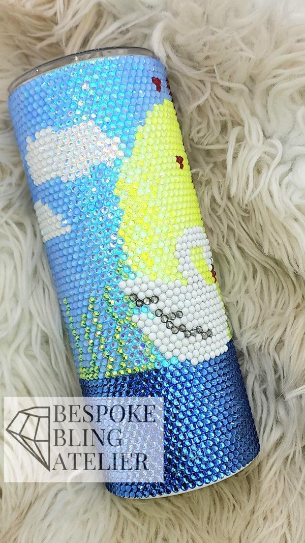Rhinestone tumbler with colorful mermaid design on fluffy white background