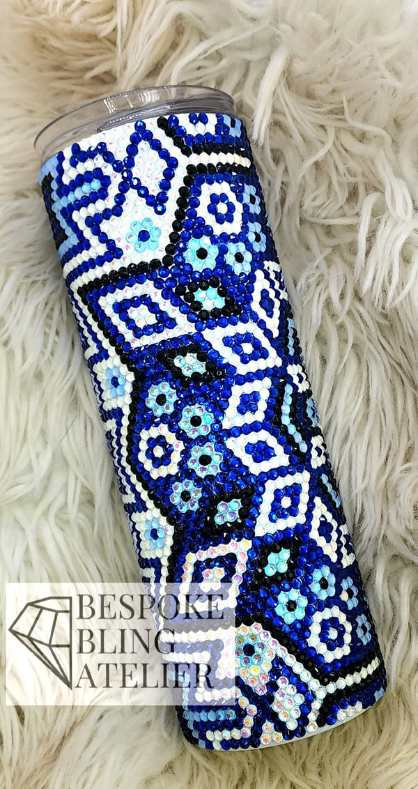 Blue and white rhinestone tumbler with floral pattern on fluffy white background