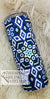 Blue and white rhinestone tumbler with intricate floral patterns on a fluffy background