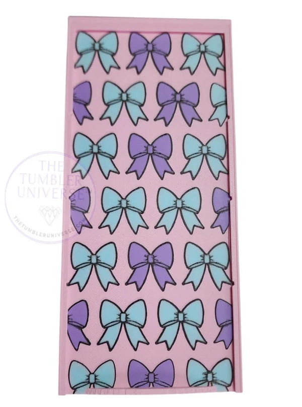 Pink rhinestone tumbler template with blue and purple bow patterns for crafting