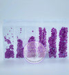 Purple rhinestones in clear organizer for tumbler crafting, featuring flatback crystals in assorted sizes