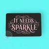 Black card with pink text 'It Needs Sparkle' on a teal background