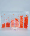 Vibrant orange rhinestones in clear packaging, perfect for crafting and bling projects.