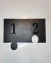 Black flatback flipper tool with numbered sides for rhinestone tumbler crafting, featuring circular cutouts.