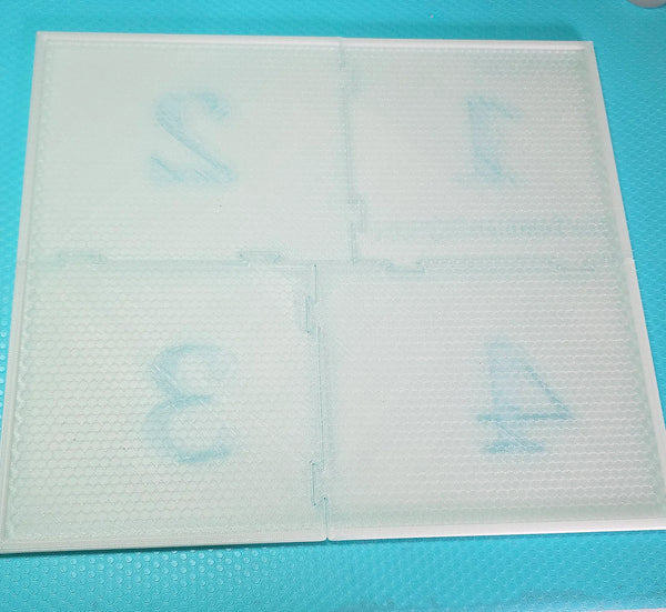 Clear rhinestone tumbler template with numbered sections on teal mat