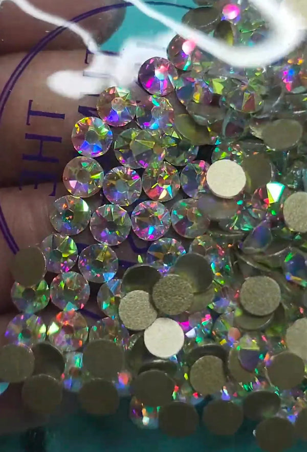 Iridescent rhinestones and flatback gems for crafting, perfect for bling projects and tumbler designs.