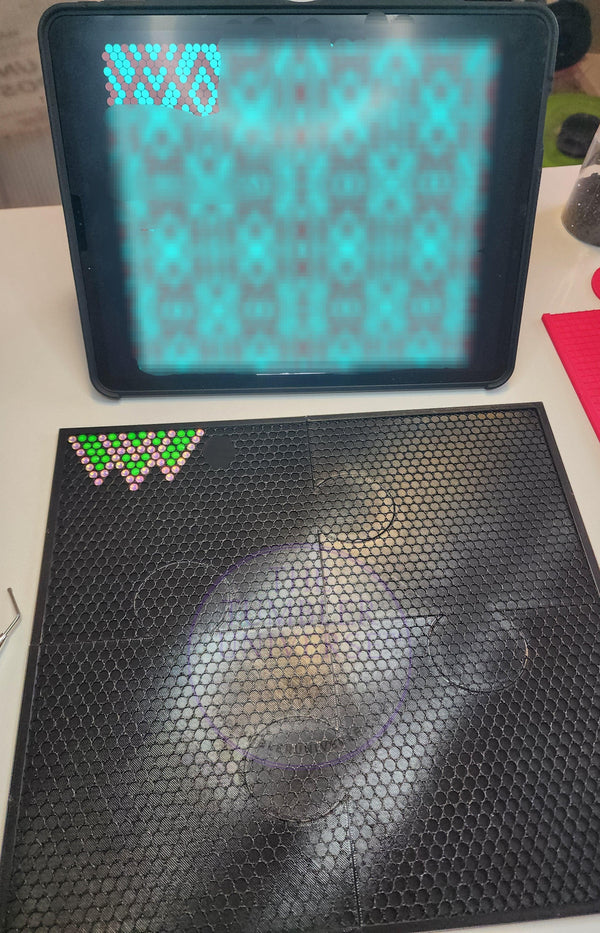 Rhinestone tumbler template with flatback flipper design, featuring colorful rhinestones on a black mesh mat for crafting.