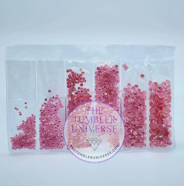 Pink rhinestones in clear organizer bag for tumbler crafting, assorted sizes and shades